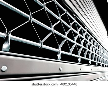 metal security shutters protecting a small shop when closed. - Powered by Shutterstock