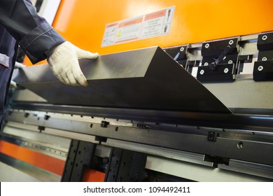 Metal Sheet Bending Machine At Work In Factory