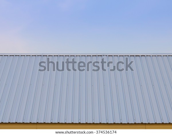 Metal sheet for\
industrial roof and blue\
sky.