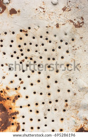 Metal sheet texture with holes and rust photo