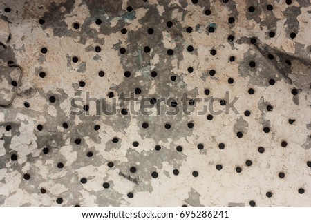 Metal sheet texture with holes and rust photo