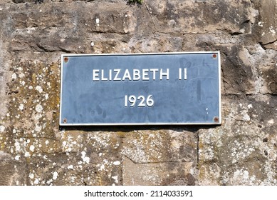 Metal Sign 'Elizabeth II 1926' On Old Rough Stone Wall 