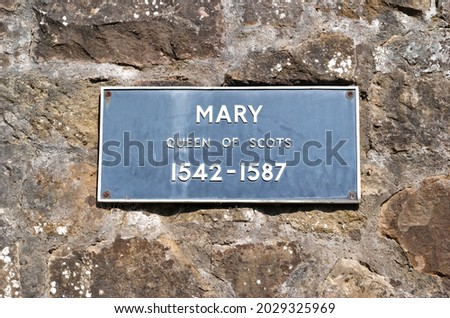 Metal Sign 'Mary Queen of Scots 1542-1587' on Old Stone Wall 