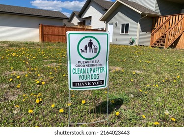 Metal Signage In The Lawn Informed A Dog Owner To Clean Their Dog Poop And Be A Good Neighbour