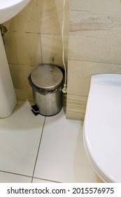 Metal Silver Garbage Can With Lid On The Floor In The Hotel Bathroom With White Tiles  On The Wall. Bathroom Modern Luxury Interior 