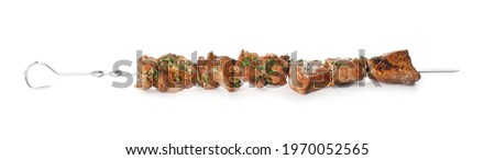 Metal skewer with delicious meat on white background
