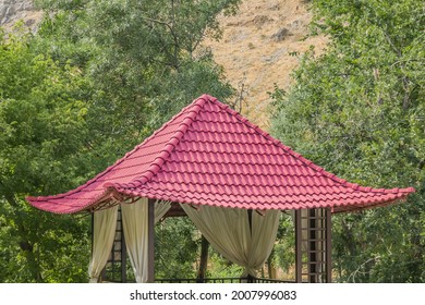 Metal Slate Gazebo Roof Close-up.Roof From A Metal Profile Against The Background Of Mountains