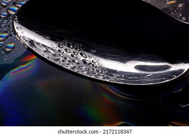 metal spoon with water drops on dark background  - Powered by Shutterstock