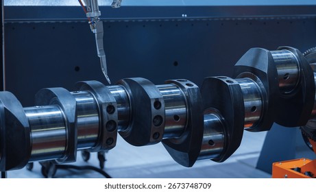 Metal spraying process for engine crankshaft parts in truck restoration workshop.
