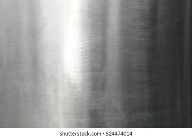 Metal stainless steel surface background or aluminum brushed silver metal texture with reflection.