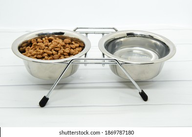 Metal stand for two bowls for dog food and water. Caring for and loving pets. Healthy balanced diet for cats and dogs. Selective focus blurred background