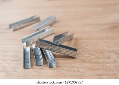 metal staples on wooden background