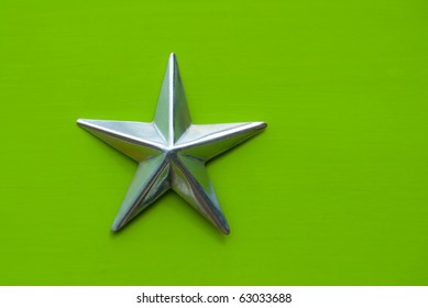 Metal Star On Green Background