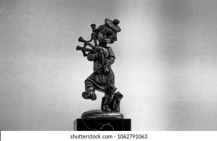 Metal Statue Of A Bagpipe Player