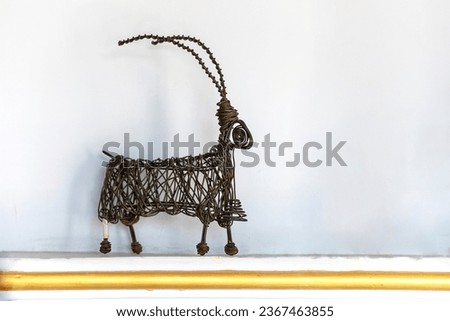 Metal statue of a quadruped with long horns. metal statue gazelle. A metal gazelle, gazelle made with metal wires