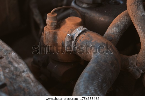 Metal steel clamp on the connection of the cooling\
system in old car motor