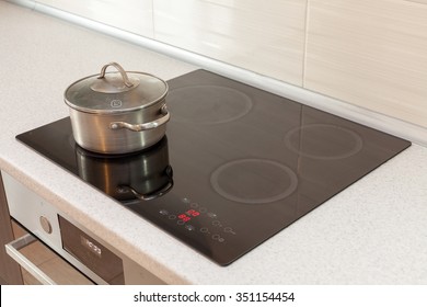 Metal steel saucepan in modern kitchen with induction stove