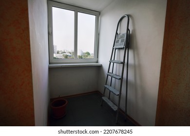 Metal Step Ladder Leaning To Empty Wall In Apartment. Renovation And Redesign In Residential Home Or Office Room.