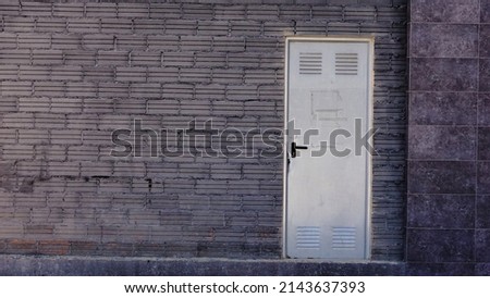 metal storage door in dark brick wall