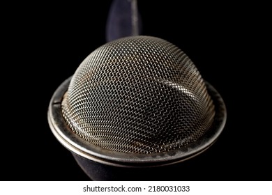 Metal Strainer For Brewing Loose Tea Close-up On A Black Background