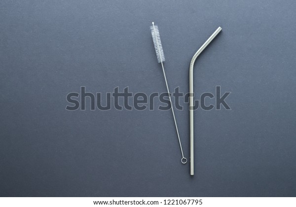 metal straw on gray background. flat lay top
view. zero waste concept