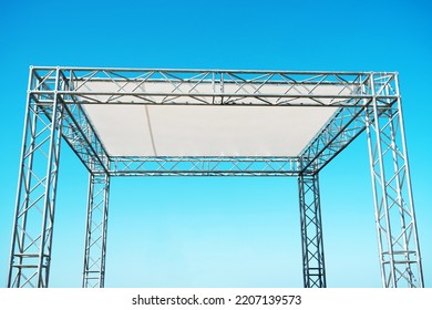 Metal structure with a woven canopy for mass events. A fragment of a mobile concert stage made of aluminum pipes. Close-up