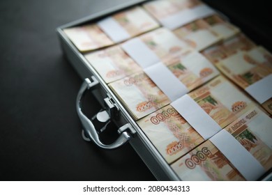 A metal suitcase filled Russian banknotes of 5000 rubles. Investment, bribe, corruption concept.
