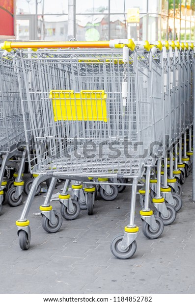 Metal supermarket\
baskets in the parking\
lot