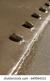 Metal surface with rivets
