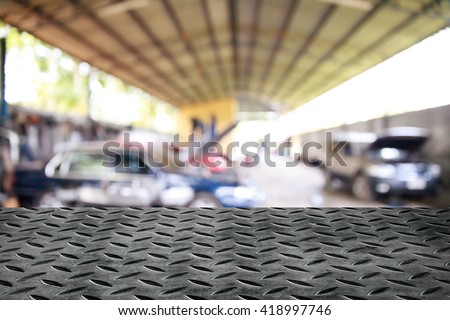 Metal table on garage background.