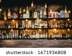 Metal table and vintage lamps  with liquor bar background