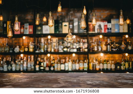Metal table and vintage lamps  with liquor bar background
