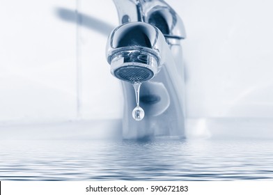 Metal tap and water drop close up