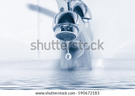 Metal tap and water drop close up