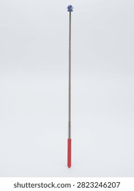 Metal telescopic pointer tool with red handle and astronaut helmet top on white background