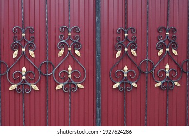 Metal Texture Of Forged Black Rods With A Pattern On The Iron Red Wall Of The Fence