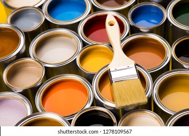 Metal tin cans with color paint and paintbrush