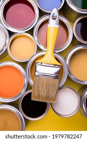 Metal tin cans with color paint and paintbrush - Shutterstock ID 1979782247