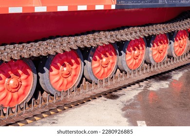 metal tracks of a crawler with red steel wheels. tracked chassis of all terrain land vehicle - Shutterstock ID 2280926885