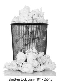 Metal trash can overflowing with paper waste isolated on white background.