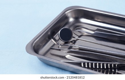 Metal Tray With Medical Instruments, Dental Equipment, On A Blue Background, Horizontal, No People, Selective Focus,