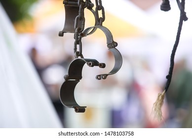 Metal Vintage Handcuffs - Shackles On A Blurred Background.