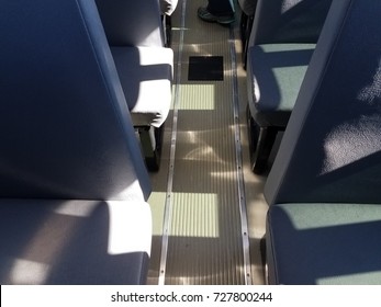 The Metal Walkway In The Aisle Of A School Bus With Seats