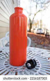 A Metal Water Bottle On A White Table In The Street On An Autumn Afternoon