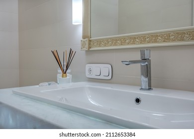 metal water tap with sink and faucet to turn on and regulate cold or hot water in expensive bathroom. 