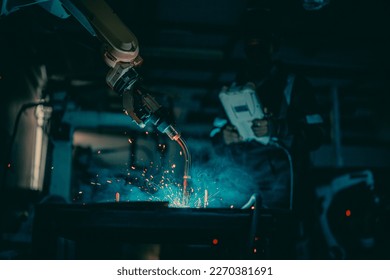 Metal welder specialist working with arc welding machine - Powered by Shutterstock