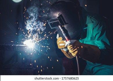 Metal welding steel works using electric arc welding machine to weld steel at factory. Metalwork manufacturing and construction maintenance service by manual skill labor concept. - Shutterstock ID 1757680625