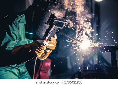 Metal welding steel works using electric arc welding machine to weld steel at factory. Metalwork manufacturing and construction maintenance service by manual skill labor concept. - Shutterstock ID 1786421933