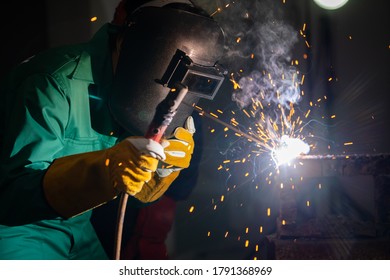 Metal welding steel works using electric arc welding machine to weld steel at factory. Metalwork manufacturing and construction maintenance service by manual skill labor concept. - Shutterstock ID 1791368969