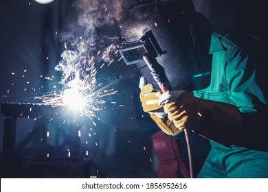 Metal welding steel works using electric arc welding machine to weld steel at factory. Metalwork manufacturing and construction maintenance service by manual skill labor concept. - Shutterstock ID 1856952616
